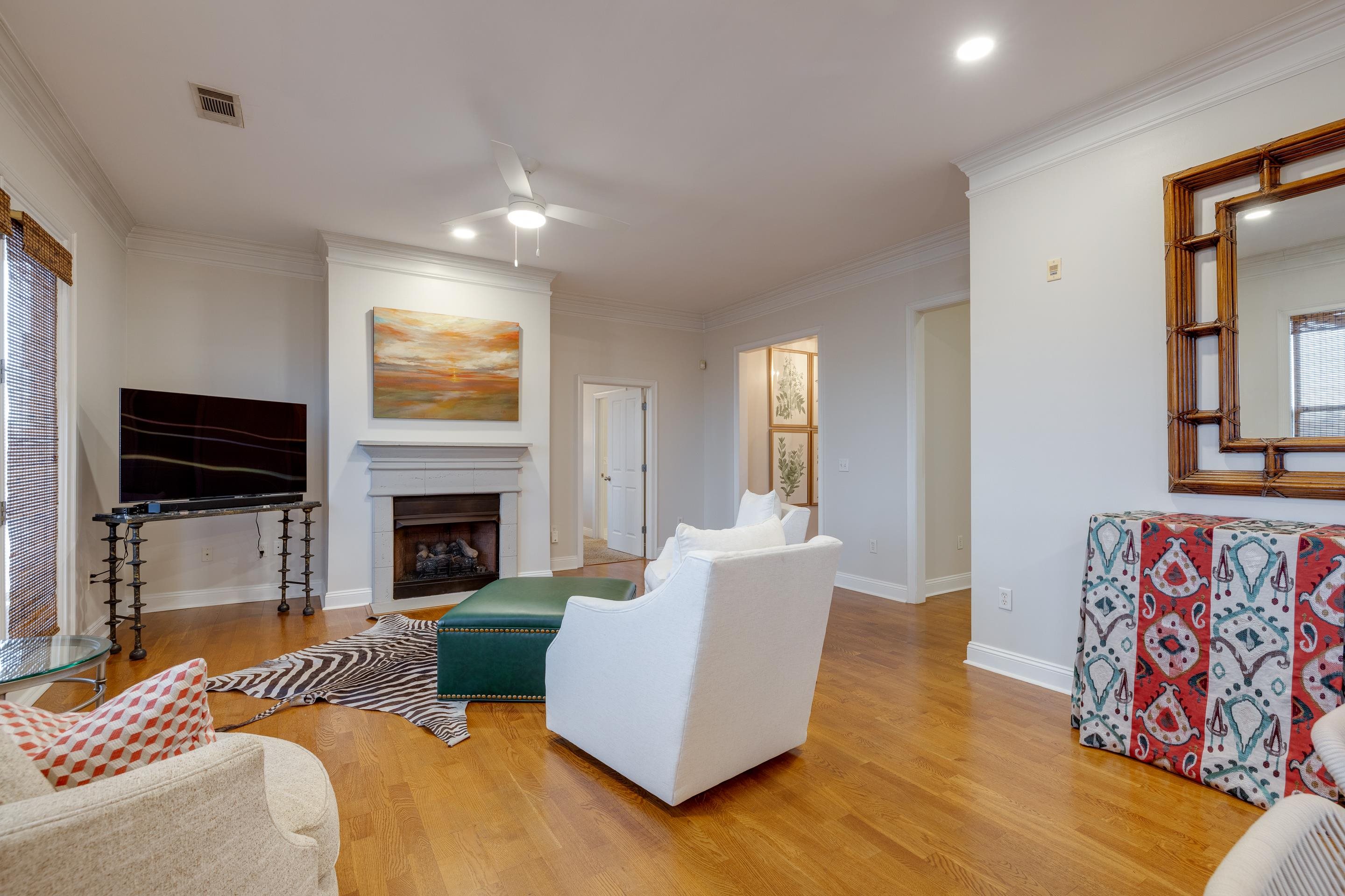 680 Harbor Bend Road, Unit 212 Memphis, TN 38103 - Photo 4 of 23 Living room featuring ceiling fan, crown molding, and light hardwood / wood-style flooring