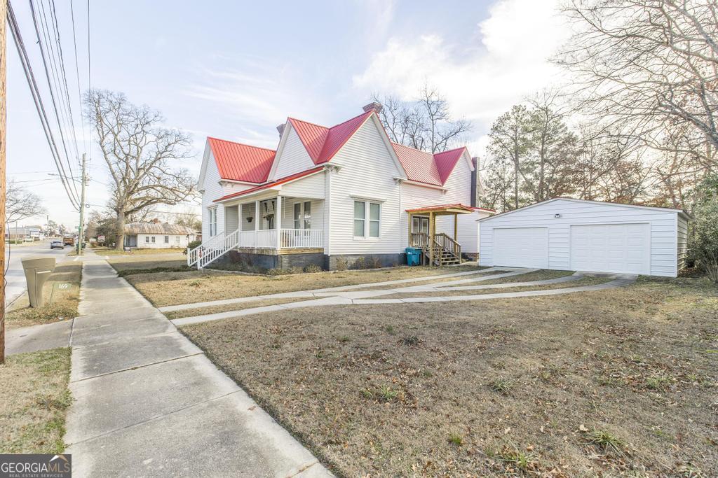 169 West Dykes Street Cochran, GA 31014 - Photo 2 of 34 a view of white house with a yard and plants