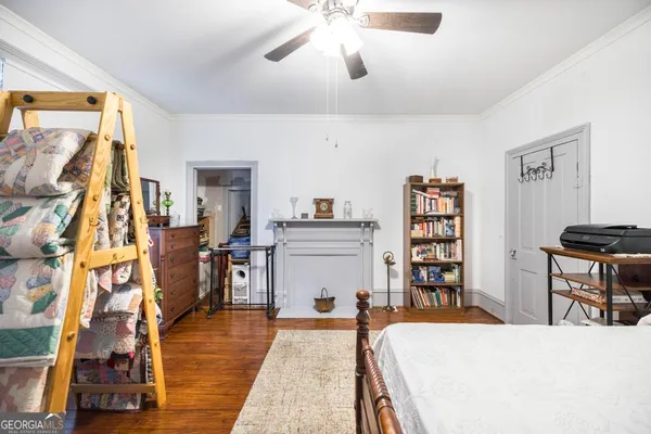a living room with a bed and a flat screen tv