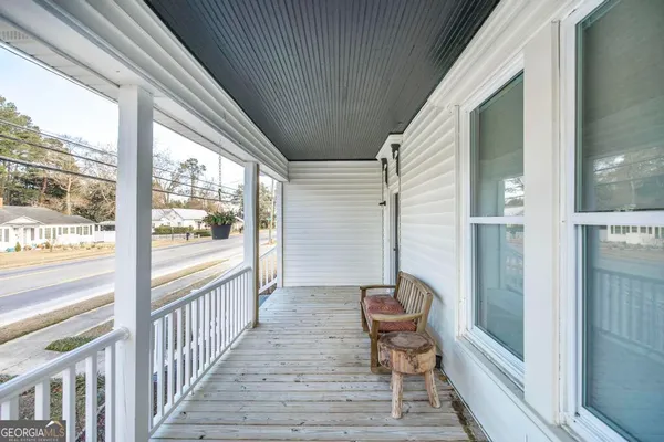 a view of a balcony with chair and the floor to ceiling window