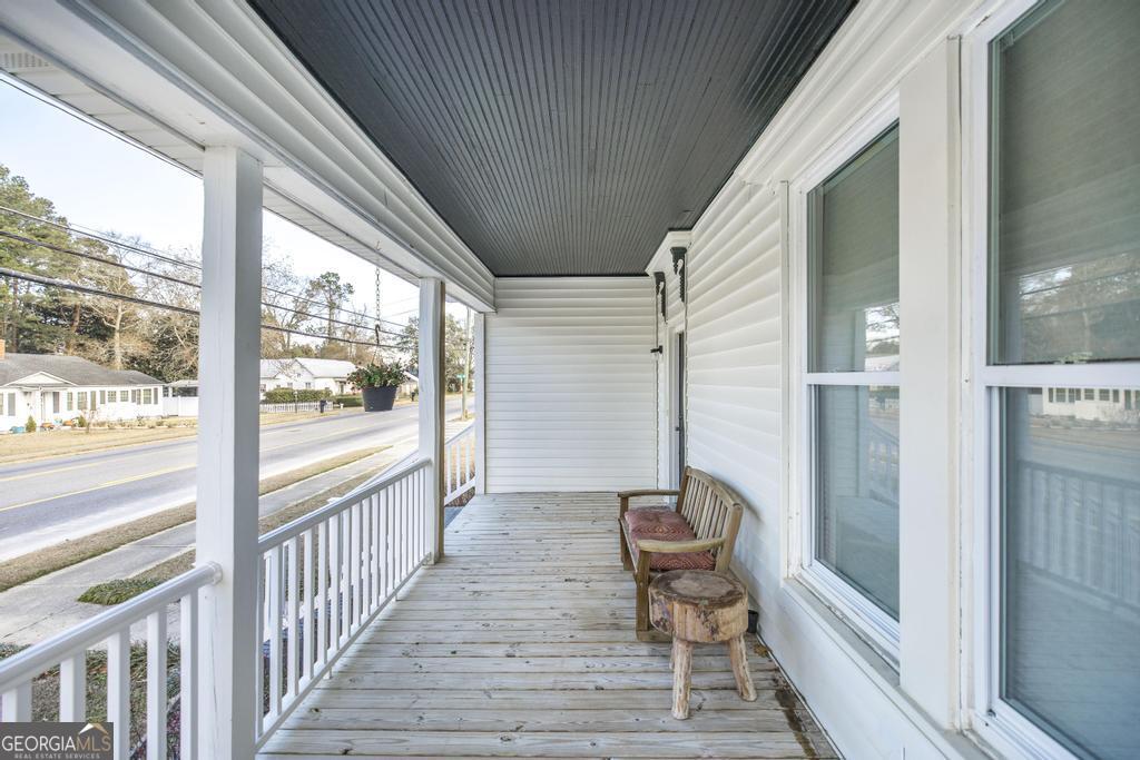 169 West Dykes Street Cochran, GA 31014 - Photo 4 of 34 a view of a balcony with chair and the floor to ceiling window