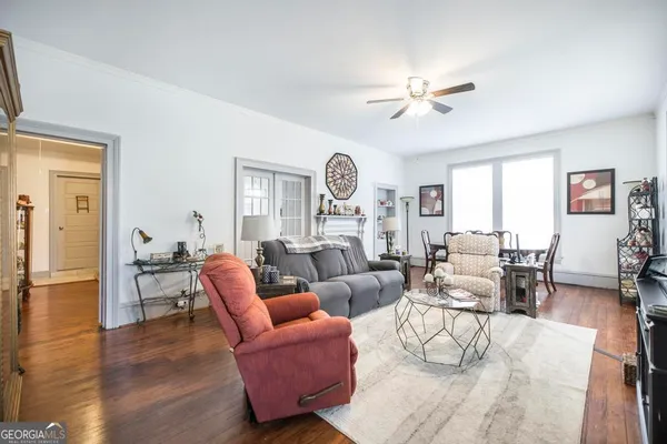 a living room with furniture a fireplace and a large window