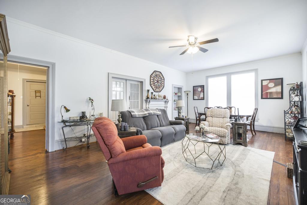 169 West Dykes Street Cochran, GA 31014 - Photo 5 of 34 a living room with furniture a fireplace and a large window