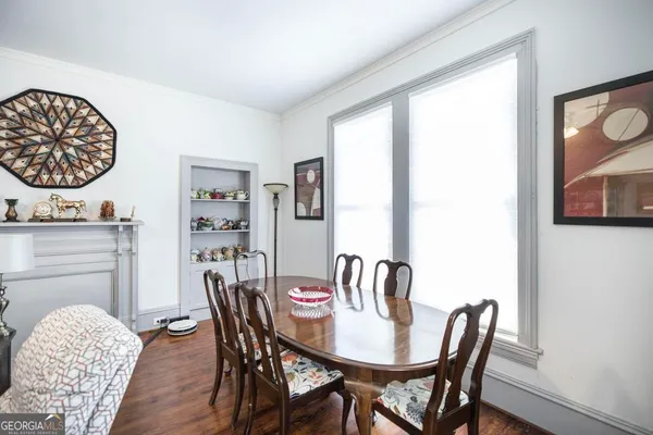 a view of a dining room with furniture window and wooden floor