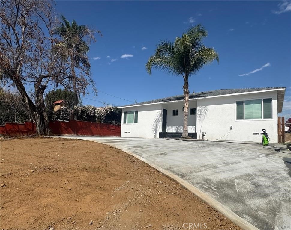 a house that has a tree in front of it