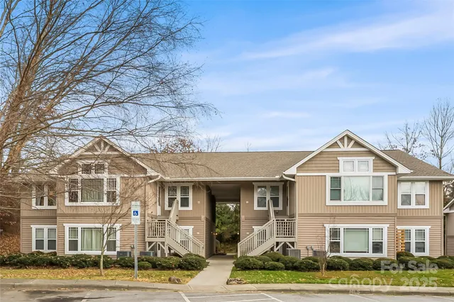 a front view of residential houses with yard