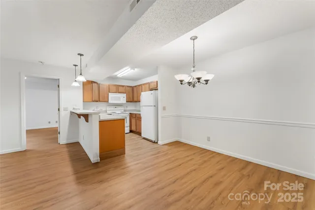 a view of a kitchen with a sink cabinet and a fireplace