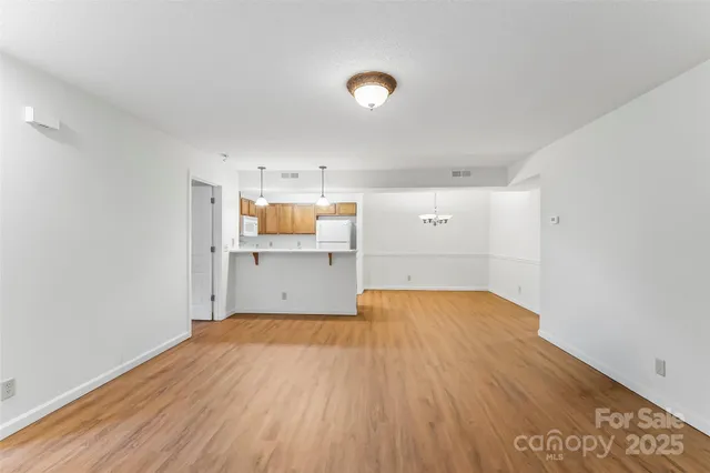 a view of a kitchen with wooden floor