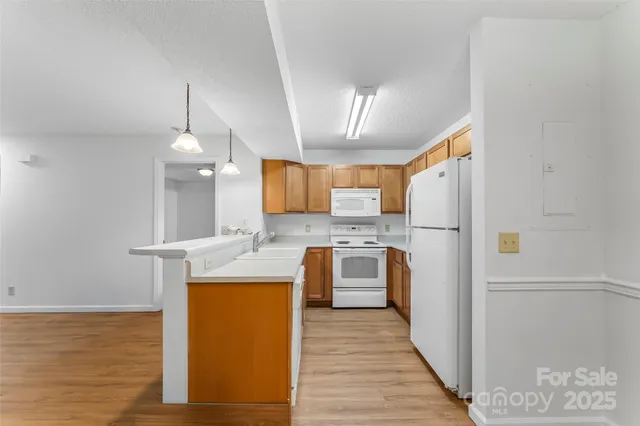 a kitchen with refrigerator and cabinets