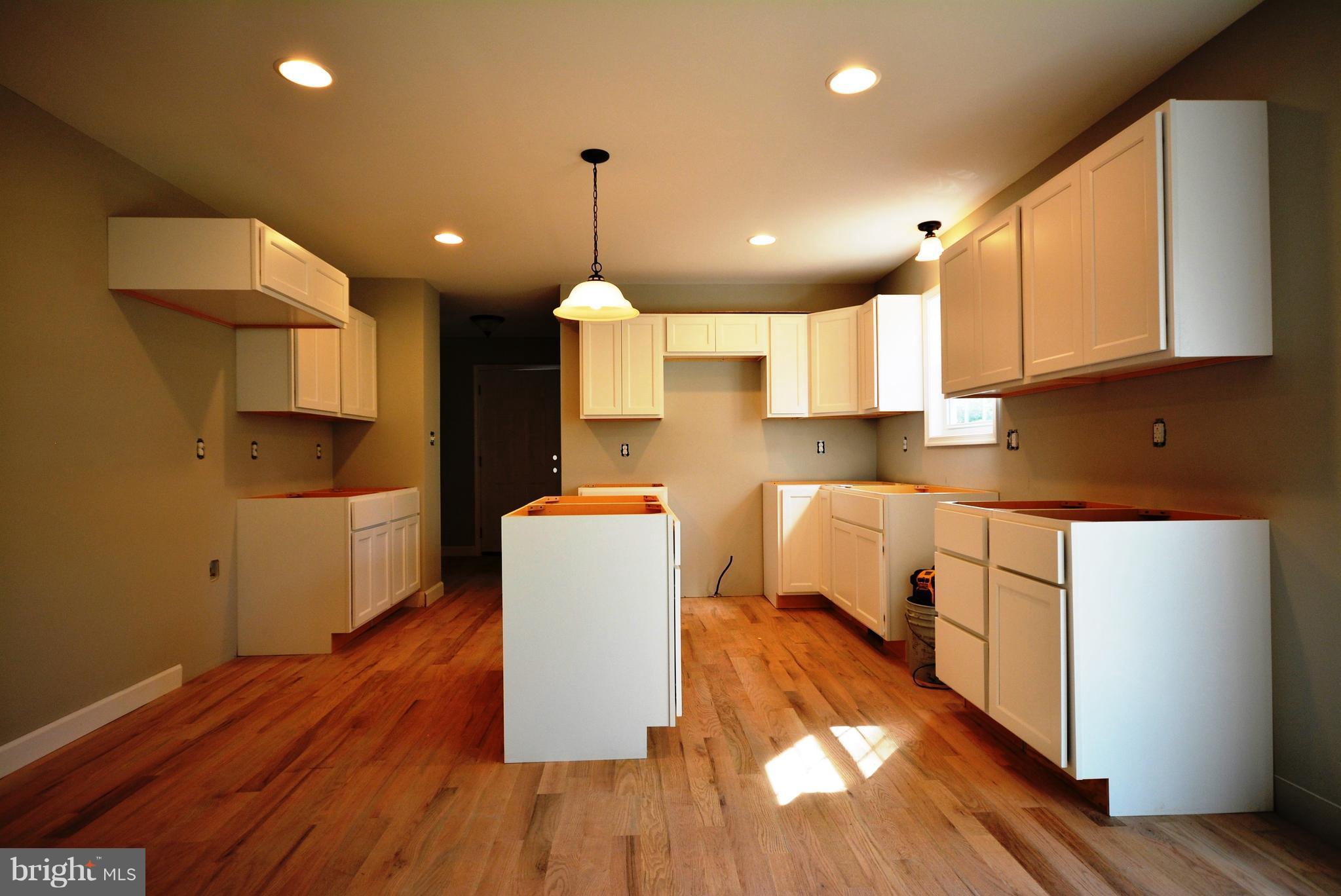 155 Lower View Road Strasburg, VA 22657 - Photo 15 of 30 a kitchen with kitchen island a stove a sink a refrigerator and wooden floor