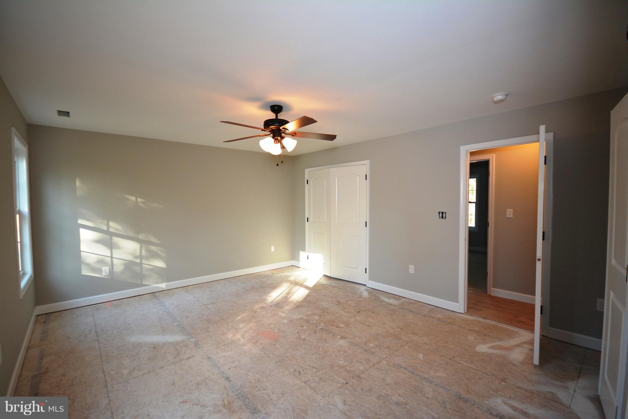 155 Lower View Road Strasburg, VA 22657 - Photo 28 of 30 an empty room with windows and chandelier fan