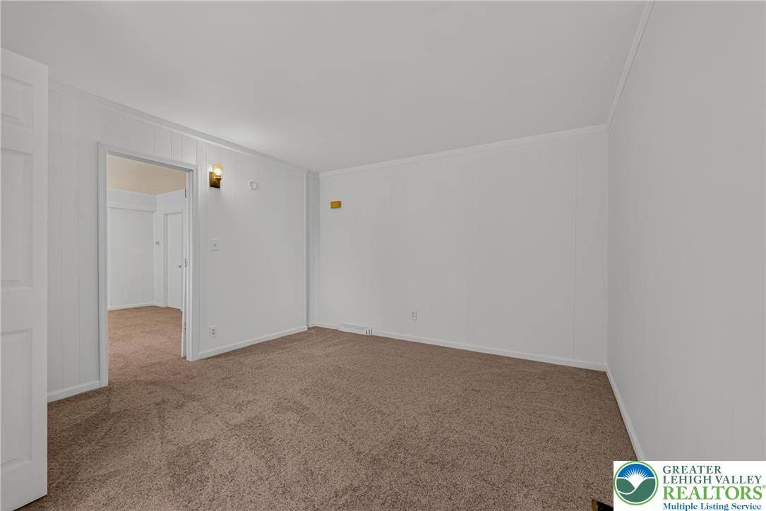 313 Main Street Slatington, PA 18080 - Photo 17 of 73 A spacious room offers plush carpeting and a doorway leading to additional interior spaces.