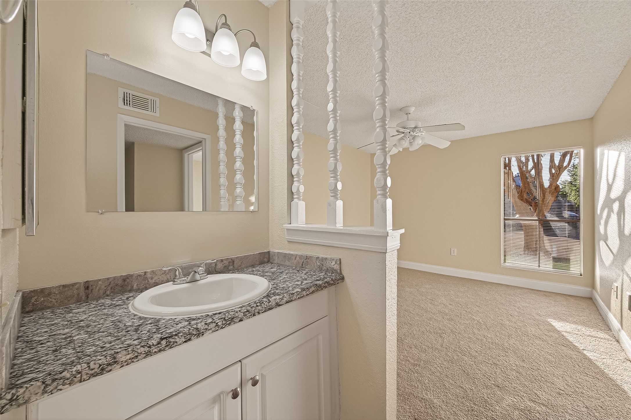 1500 Bay Area Boulevard, Unit 183 Houston, TX 77058 - Photo 16 of 24 a bathroom with a granite countertop sink and a mirror