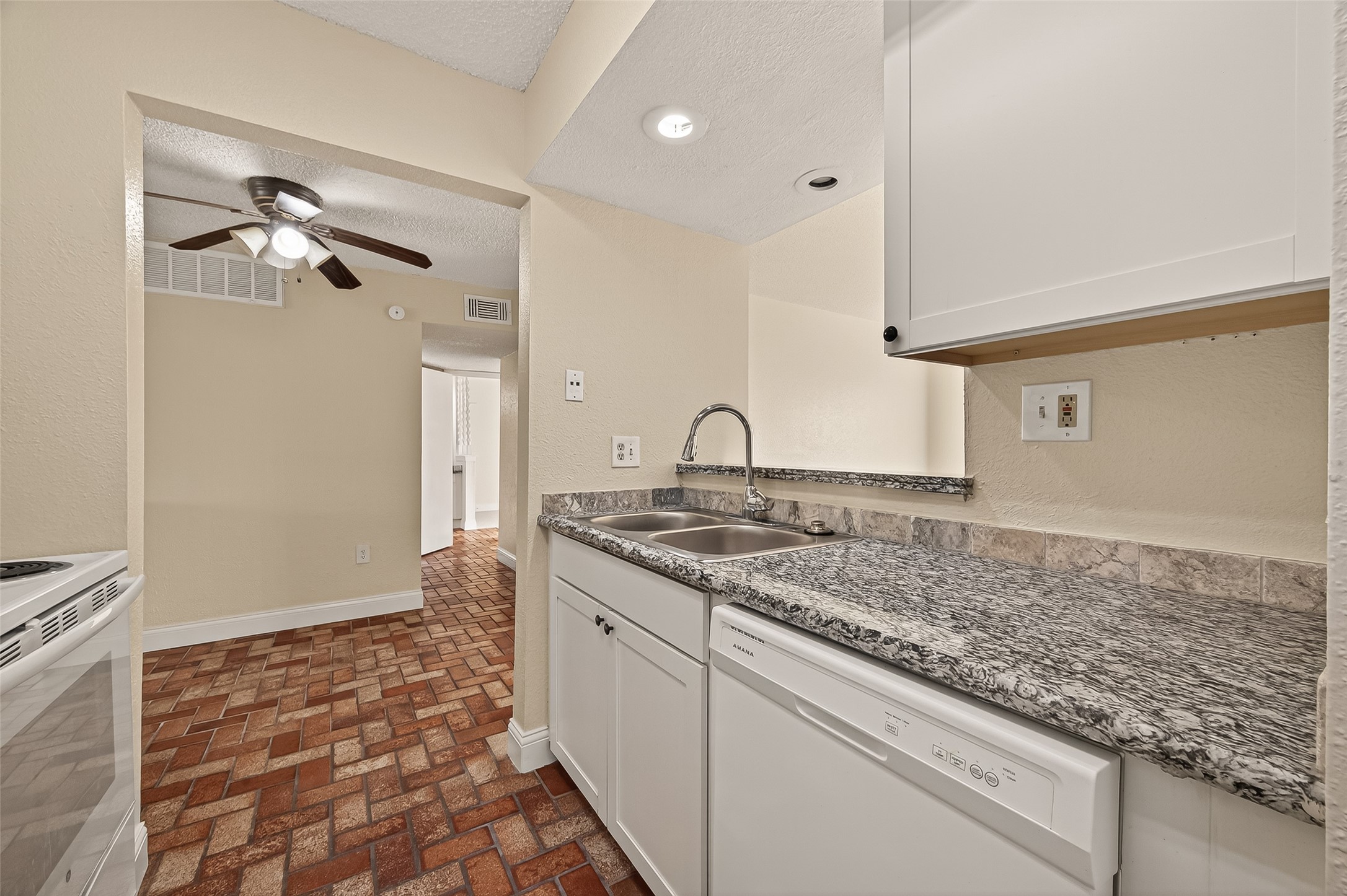 1500 Bay Area Boulevard, Unit 183 Houston, TX 77058 - Photo 9 of 24 a kitchen with a sink and a stove top oven