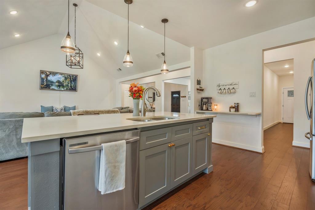 1909 Willowcrest Loop Denton, TX 76205 - Photo 38 of 40 Island with gray cabinets, stainless steel appliances, open floor plan, decorative light fixtures, and recessed lighting
