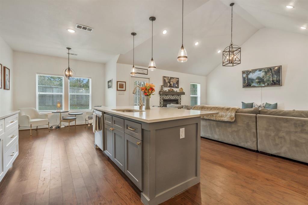 1909 Willowcrest Loop Denton, TX 76205 - Photo 39 of 40 Kitchen featuring decorative light fixtures, open floor plan, dark wood-type flooring, an island with sink, and recessed lighting