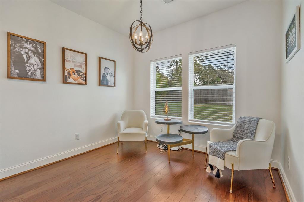 1909 Willowcrest Loop Denton, TX 76205 - Photo 15 of 40 Second eating area overlooking lovely backyard, wood-type flooring and a chandelier