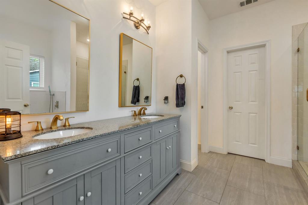 1909 Willowcrest Loop Denton, TX 76205 - Photo 19 of 40 Bathroom with double vanity and tiled shower
