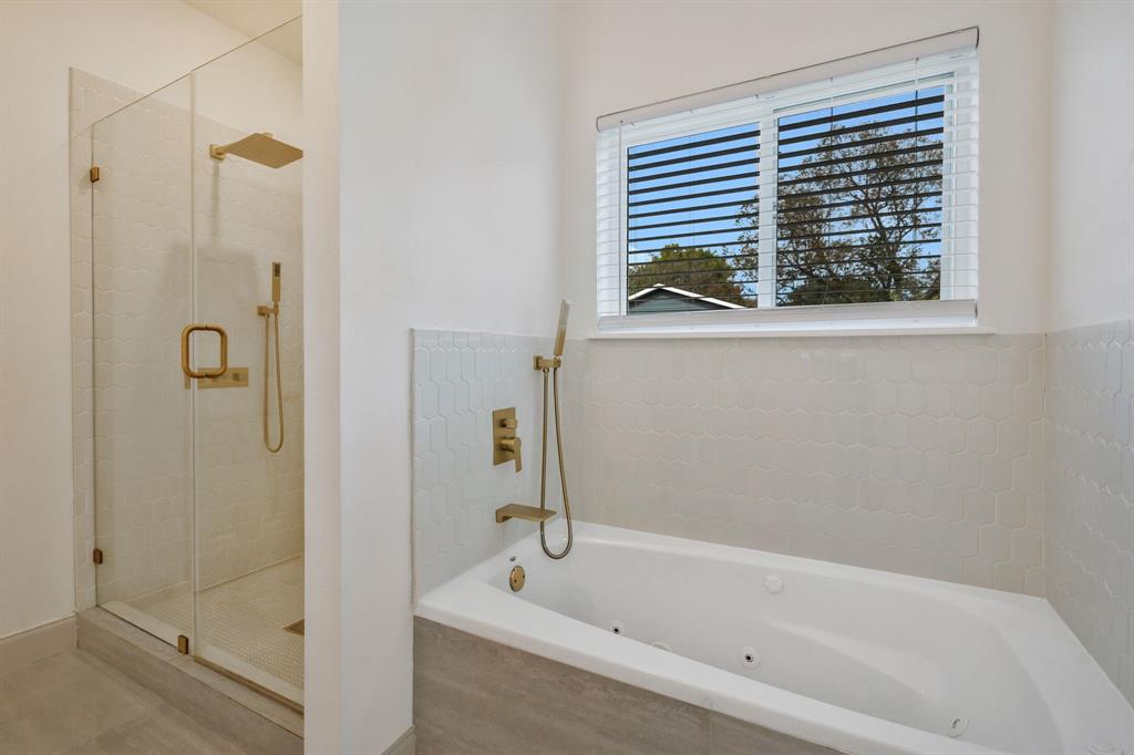 1909 Willowcrest Loop Denton, TX 76205 - Photo 21 of 40 Bathroom with a jetted tub and a stall shower