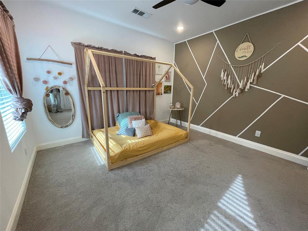 1909 Willowcrest Loop Denton, TX 76205 - Photo 25 of 40 Bedroom featuring a ceiling fan, carpet, recessed lighting, and an accent wall