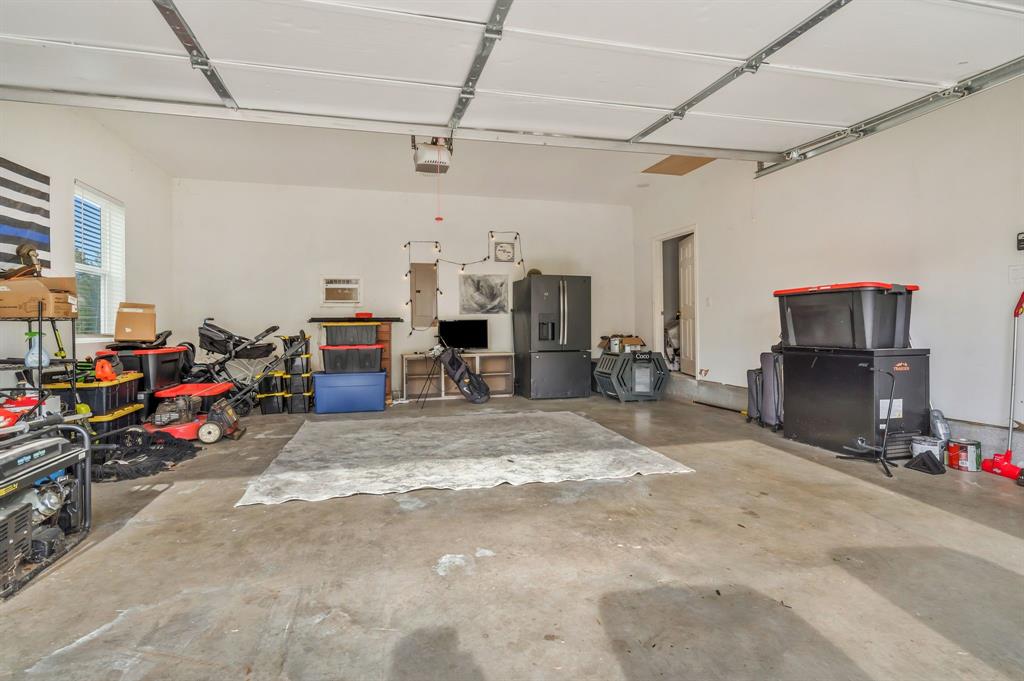 1909 Willowcrest Loop Denton, TX 76205 - Photo 31 of 40 Garage with air and heat and plenty of work space