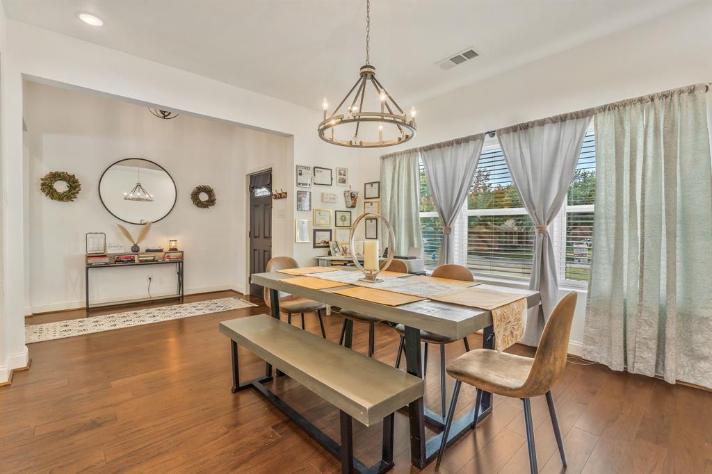 1909 Willowcrest Loop Denton, TX 76205 - Photo 5 of 40 Dining room with dark wood-type flooring and a chandelier