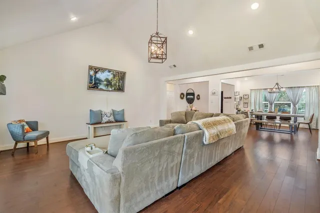 a kitchen with kitchen island a counter top space a sink stainless steel appliances and cabinets