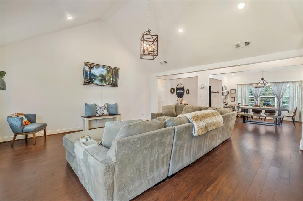 1909 Willowcrest Loop Denton, TX 76205 - Photo 9 of 40 Living area featuring dark wood-type flooring, high vaulted ceiling, and recessed lighting