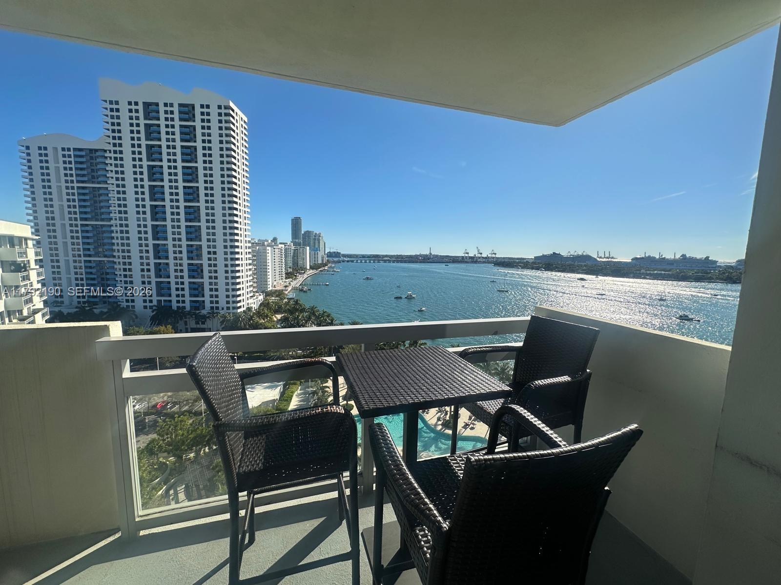 a balcony with a table and chairs