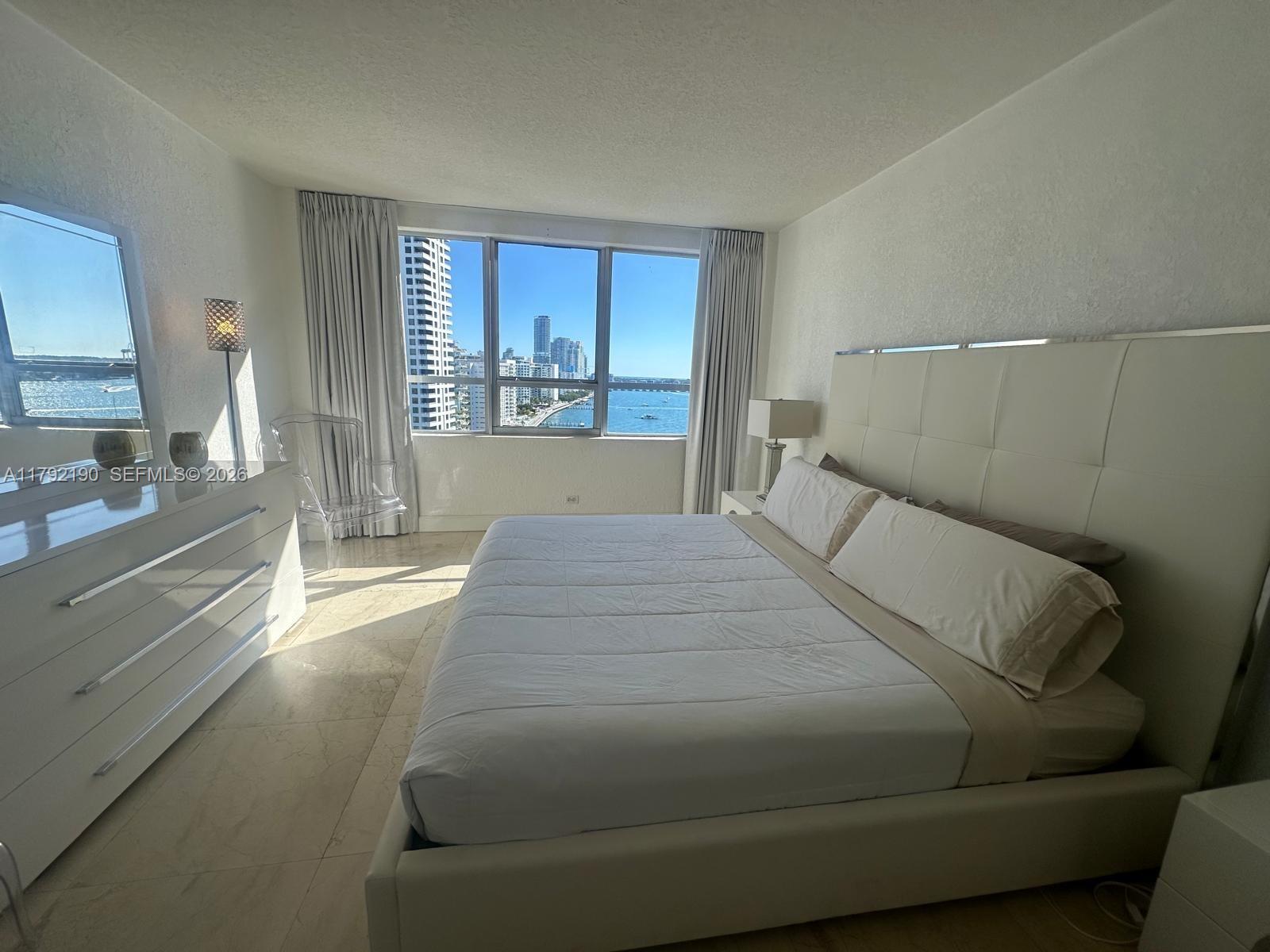 1500 Bay Road, Unit 1528S Miami Beach, FL 33139 - Photo 13 of 29 a bedroom with a large bed and a large window
