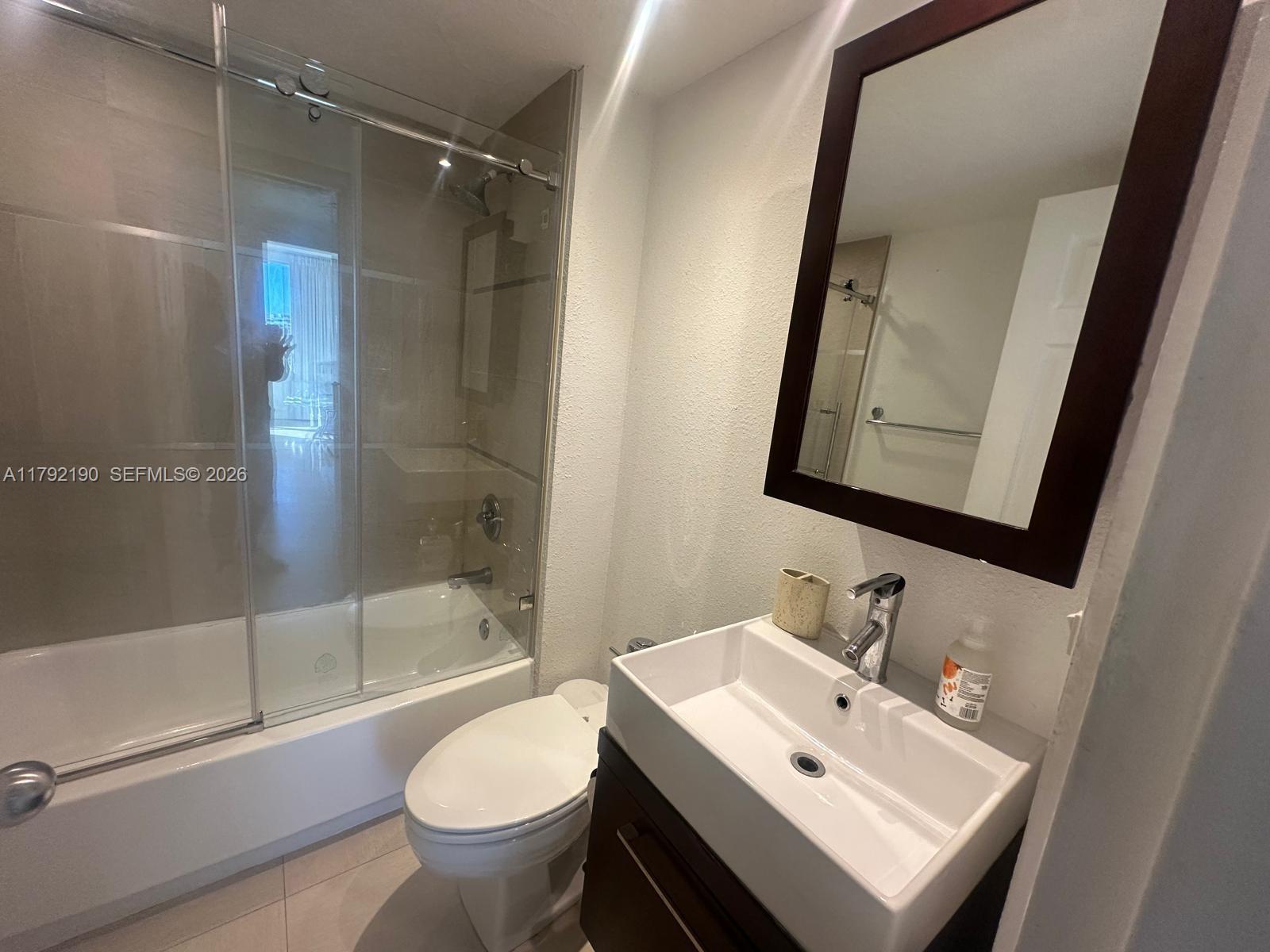 1500 Bay Road, Unit 1528S Miami Beach, FL 33139 - Photo 14 of 29 a bathroom with a sink toilet and shower