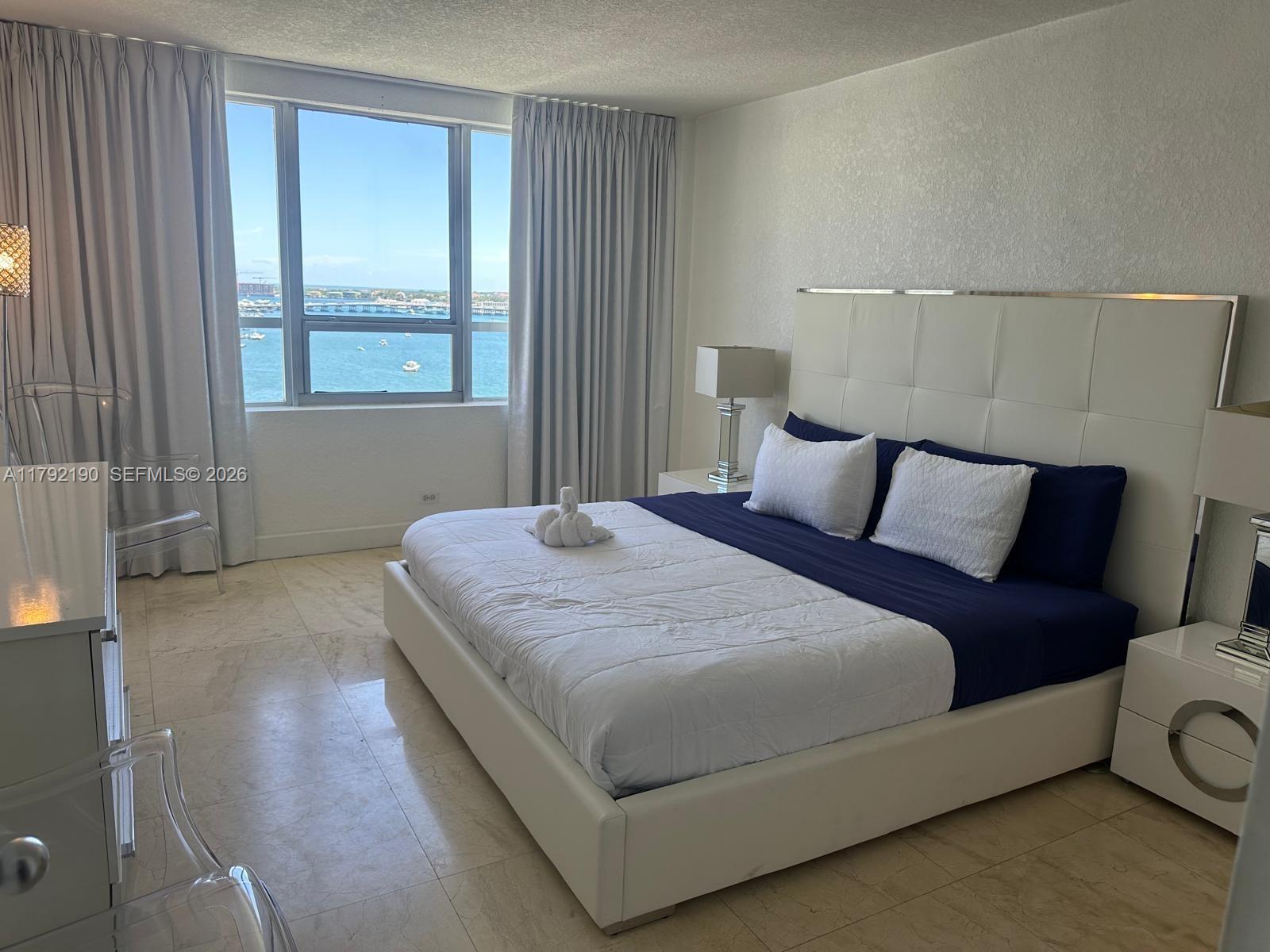 1500 Bay Road, Unit 1528S Miami Beach, FL 33139 - Photo 15 of 29 a bedroom with a bed and window