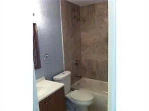 a white toilet sitting next to a bathroom sink