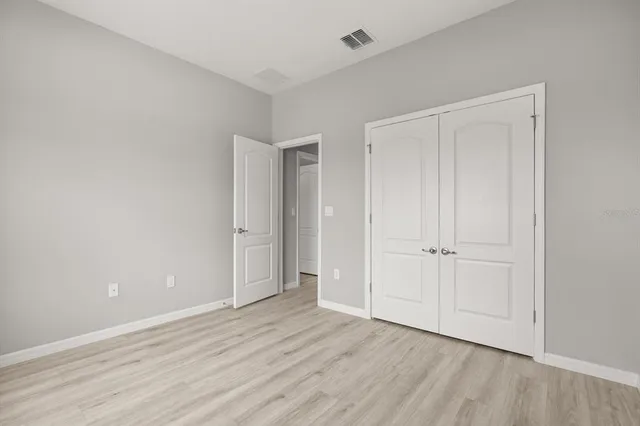 a view of an empty room and wooden floor