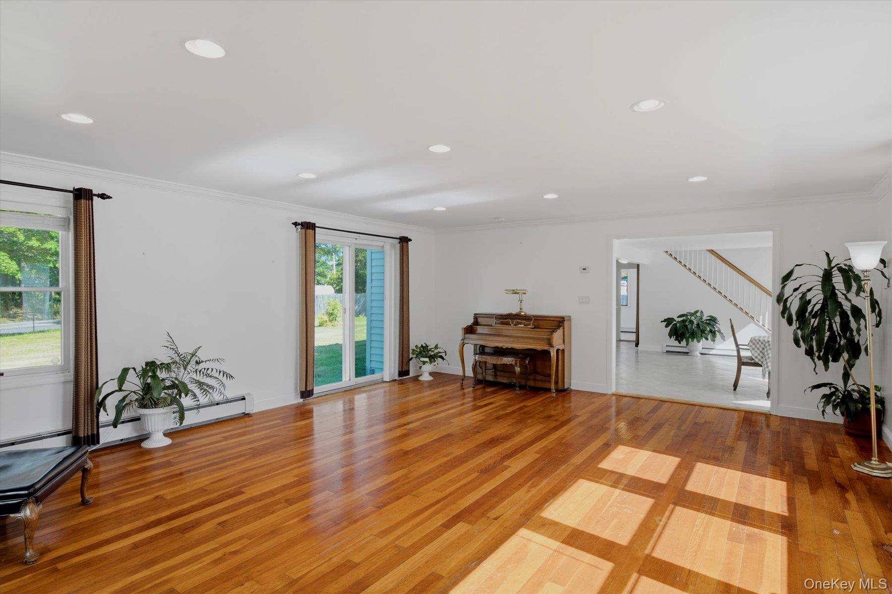 498 Miller Place Road Miller Place, NY 11764 - Photo 6 of 37 Gleaming Hardwood floors, Tons of large anderson windows to make this a well naturally lite family room
