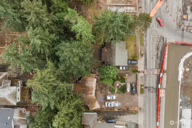 an aerial view of a house with a yard and street