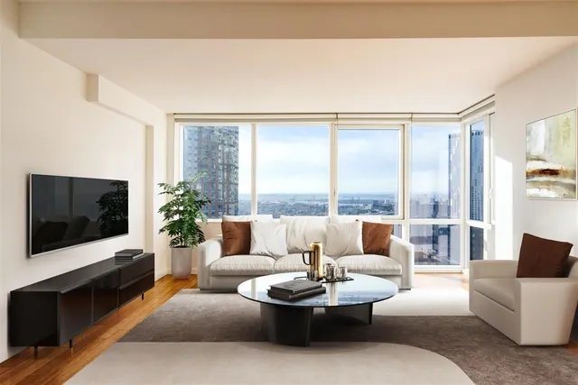 a living room with furniture a flat screen tv and a large window
