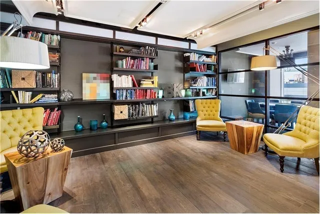 a living room with furniture and a book shelf