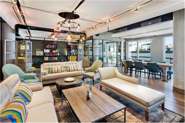 a living room with patio furniture and a chandelier