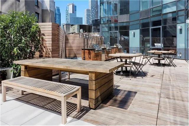 a view of a patio with couches table and chairs potted plants and palm tree