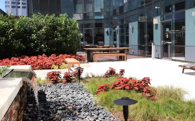a view of a patio with table and chairs potted plants