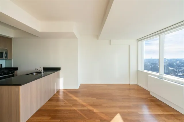 a kitchen with granite countertop a sink and a stove top oven