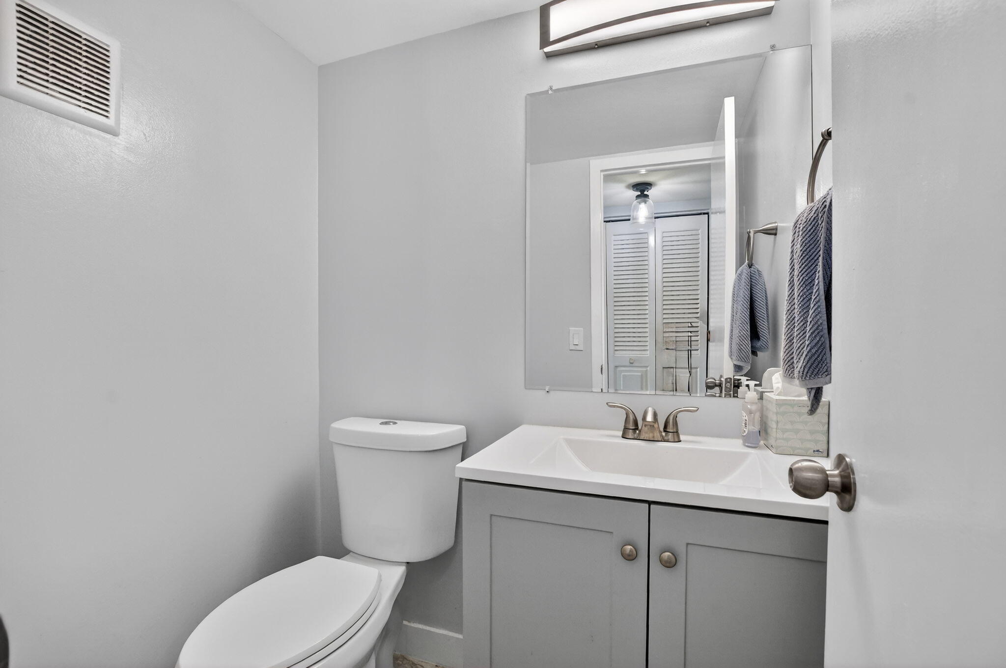 485 Mansfield K Boca Raton, FL 33434 - Photo 17 of 73 a bathroom with a toilet sink and mirror