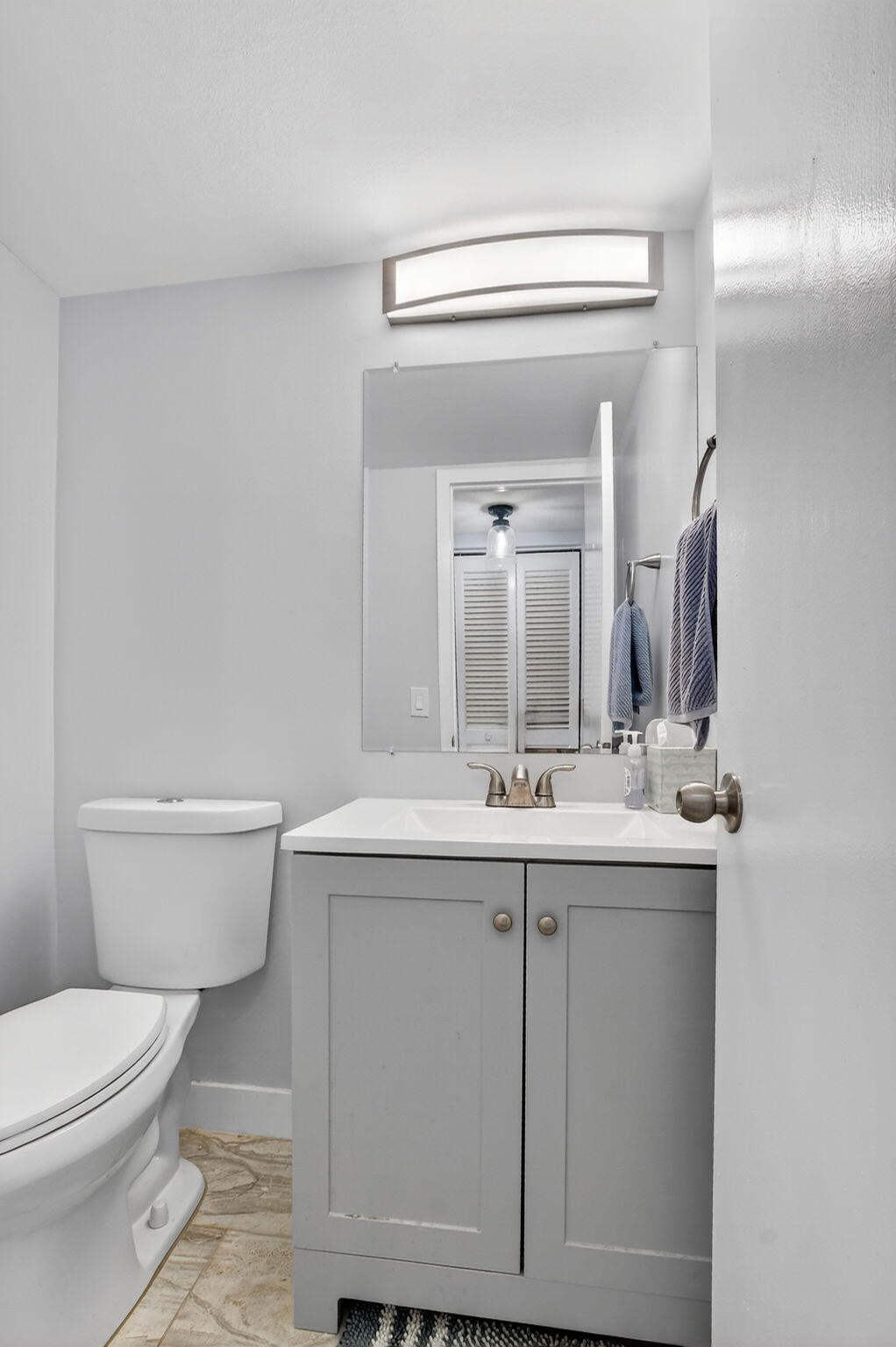 485 Mansfield K Boca Raton, FL 33434 - Photo 18 of 73 a bathroom with a toilet a sink and mirror