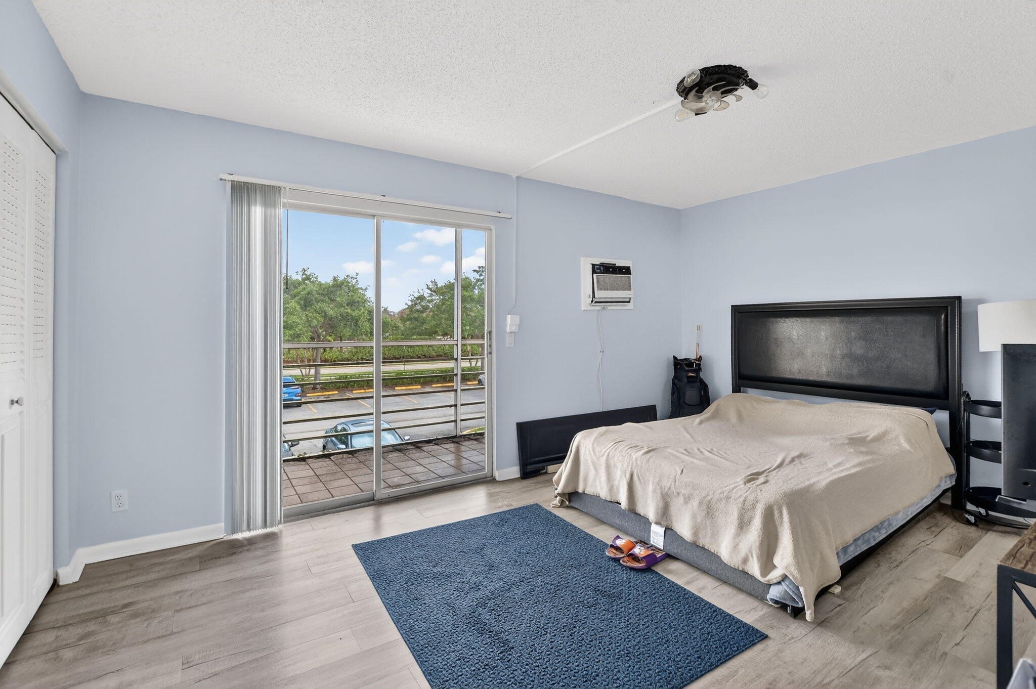 485 Mansfield K Boca Raton, FL 33434 - Photo 19 of 73 a bedroom with a bed lamp and window
