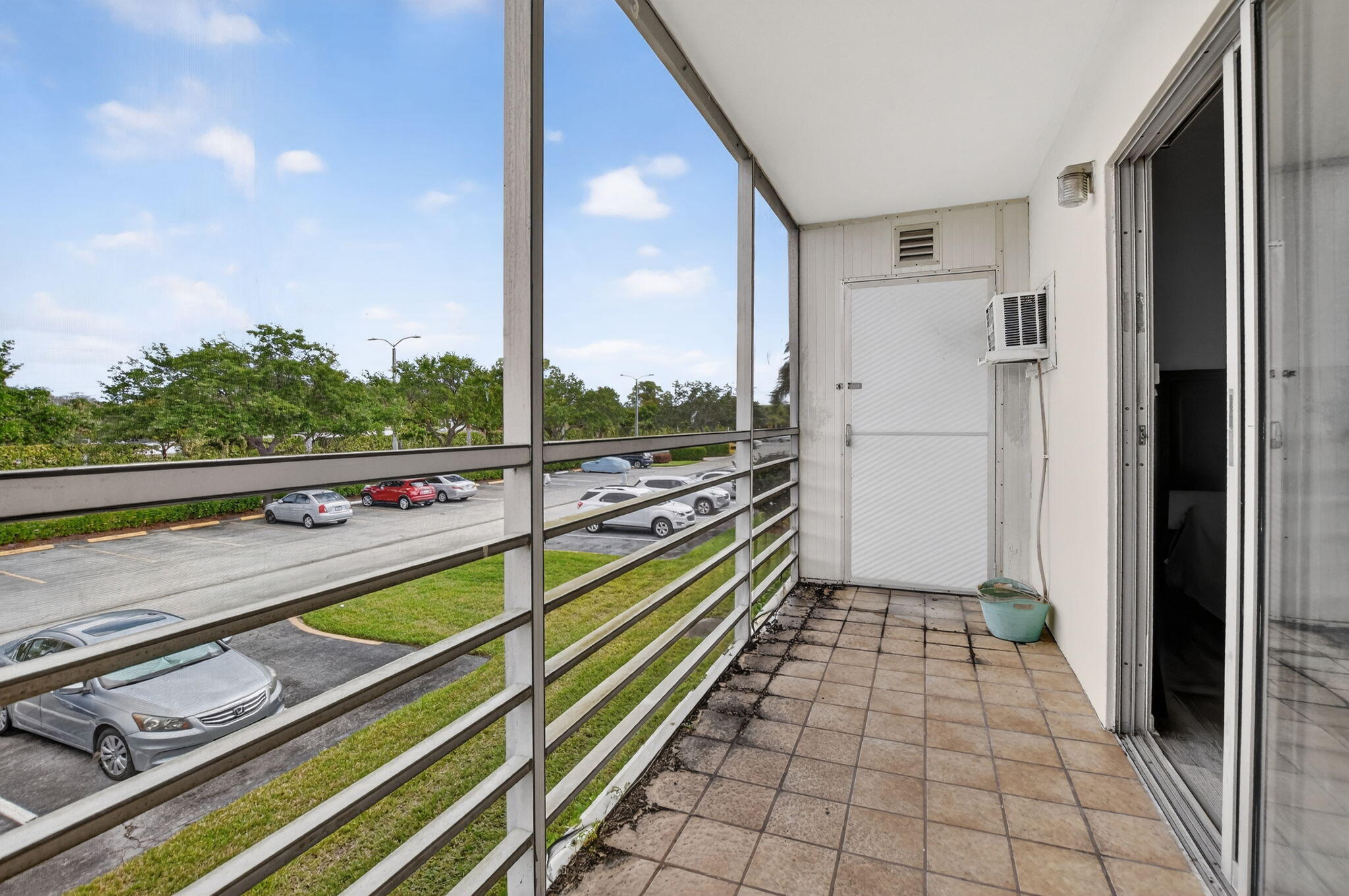 485 Mansfield K Boca Raton, FL 33434 - Photo 26 of 73 a view of a balcony with floor to ceiling windows with wooden floor