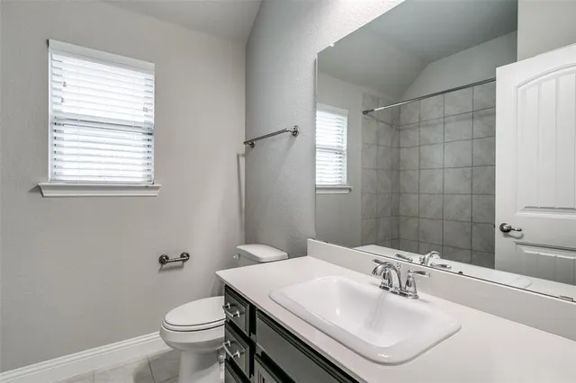 a bathroom with a sink toilet and mirror