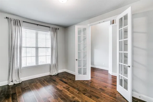 a view of wooden floor and windows in a room