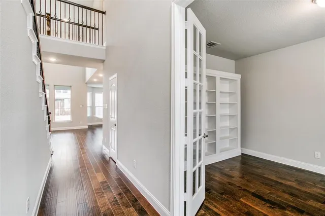 a view of a hallway view with wooden floor and staircase