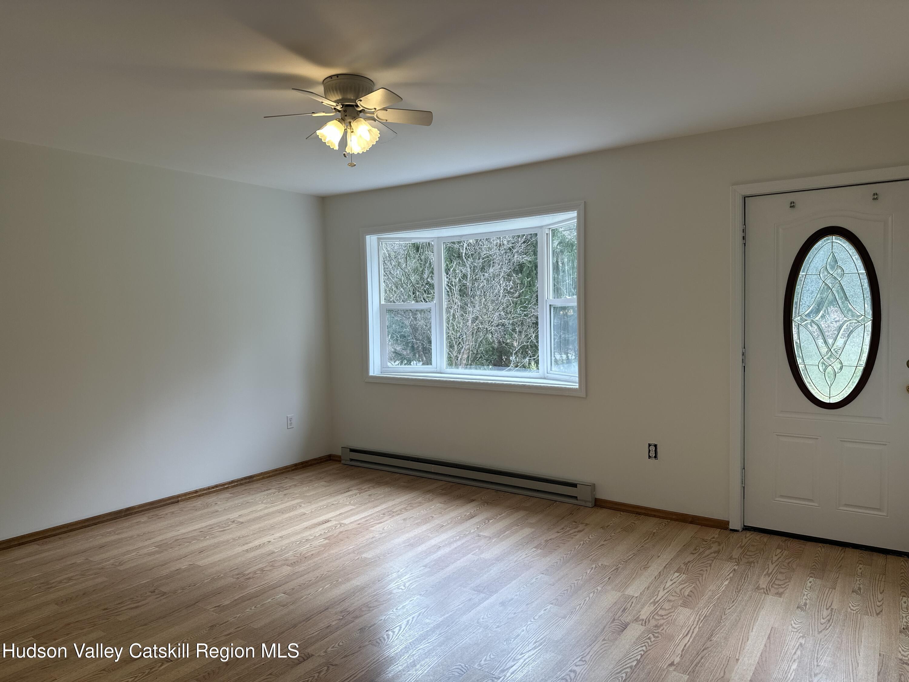 470 Edison Timmerman Road Cairo, NY 12413 - Photo 11 of 29 an empty room with wooden floor and windows